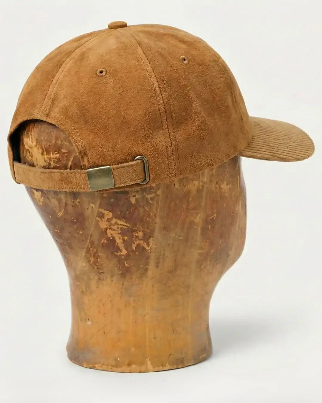 Brown suede baseball cap with adjustable strap, teeside accessory on display head