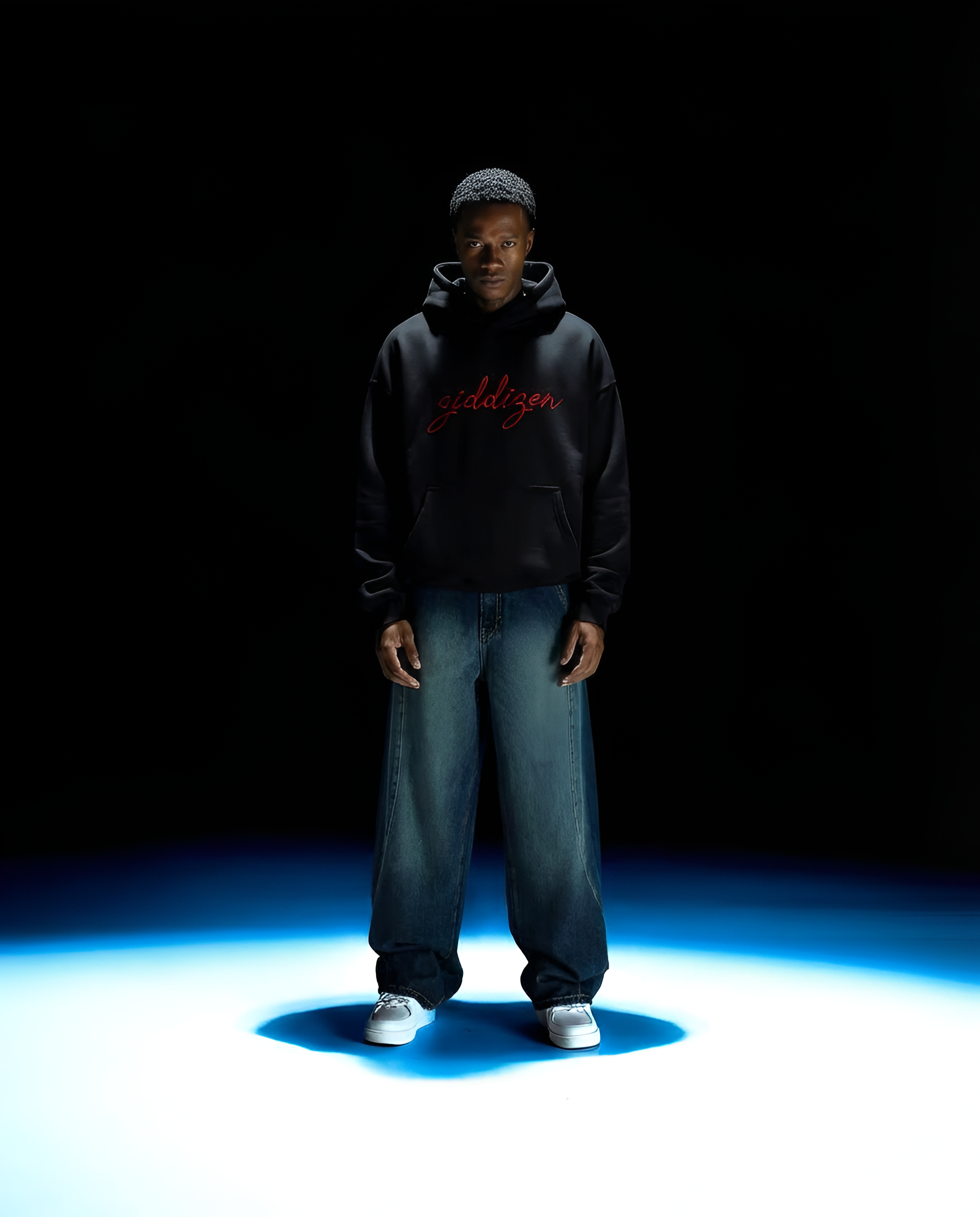 Person wearing a black hoodie with red text on a dark background